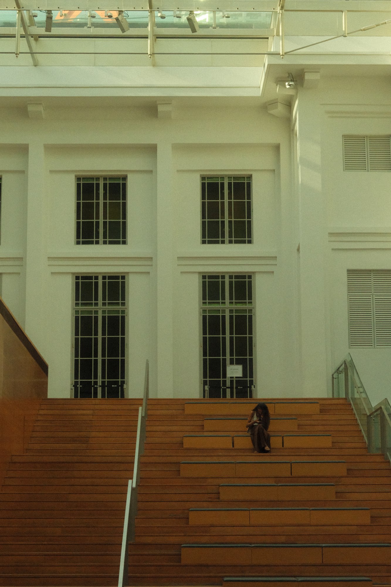 A person on the steps of a white building