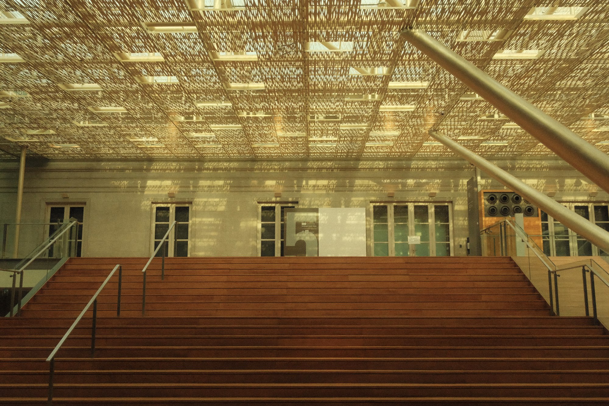 A grand staircase beneath a glass roof