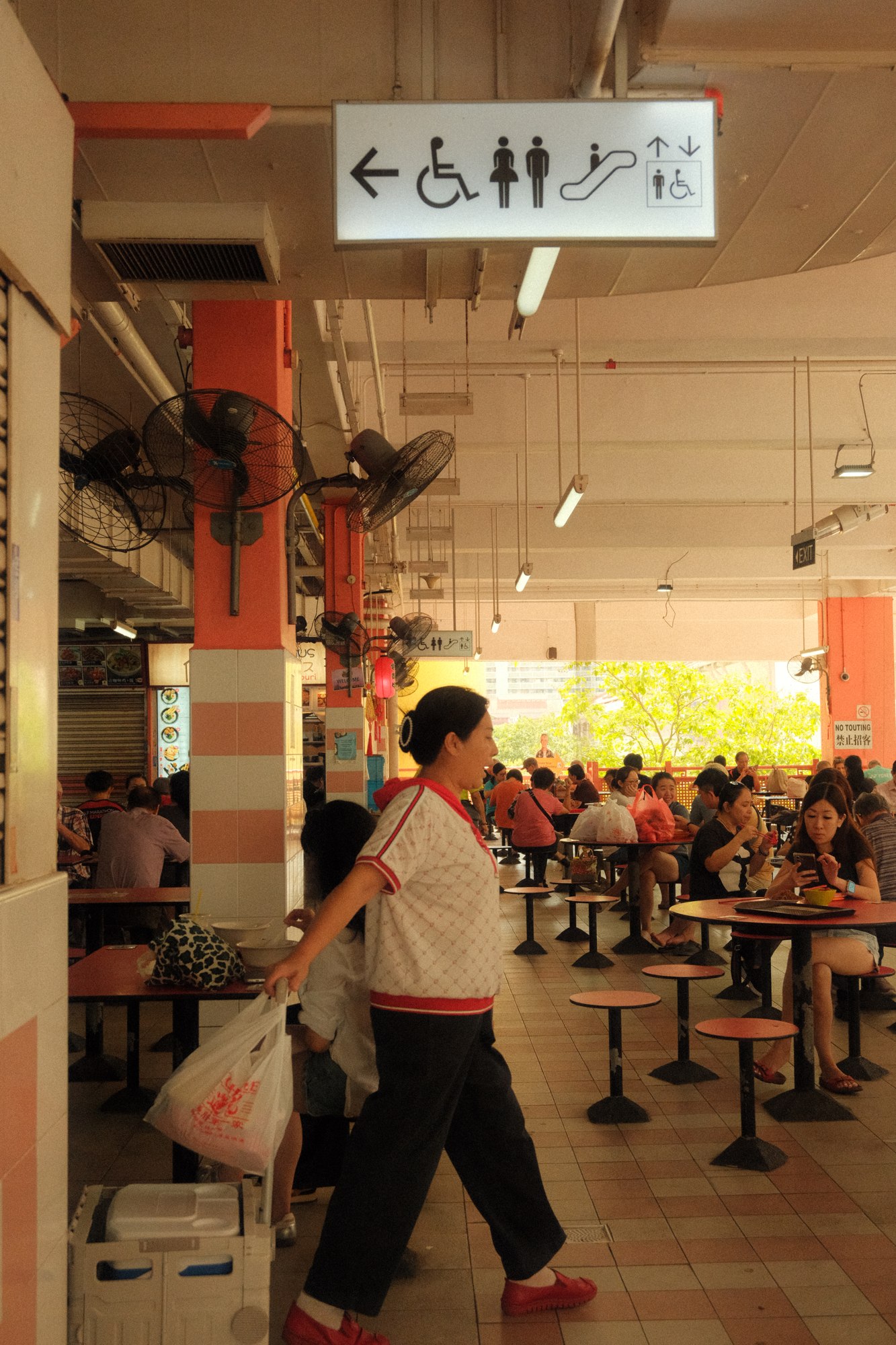 A person outside a busy food stall
