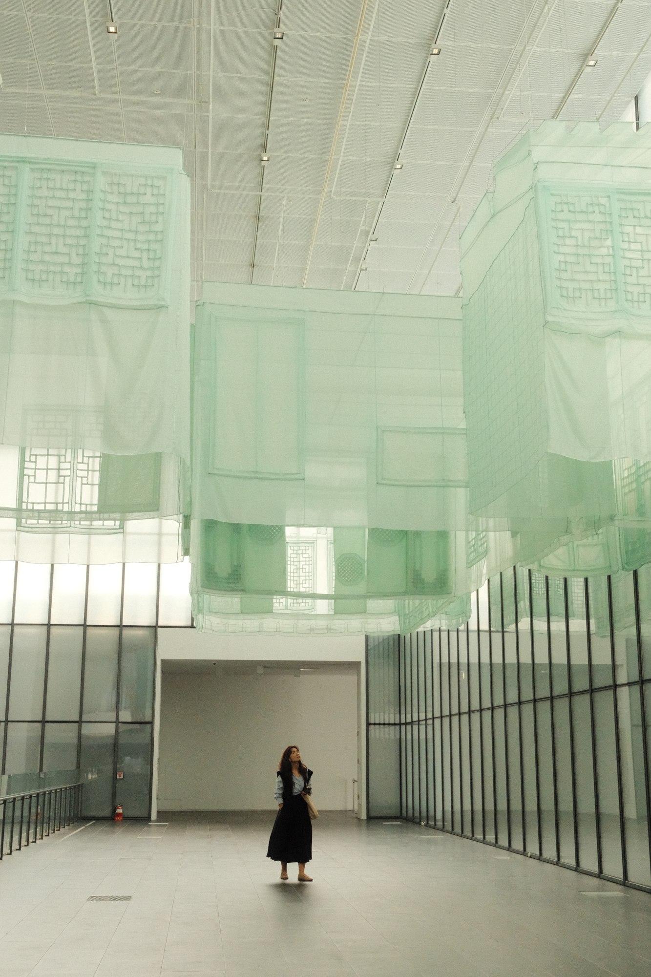 A lone person in a light-filled modern interior